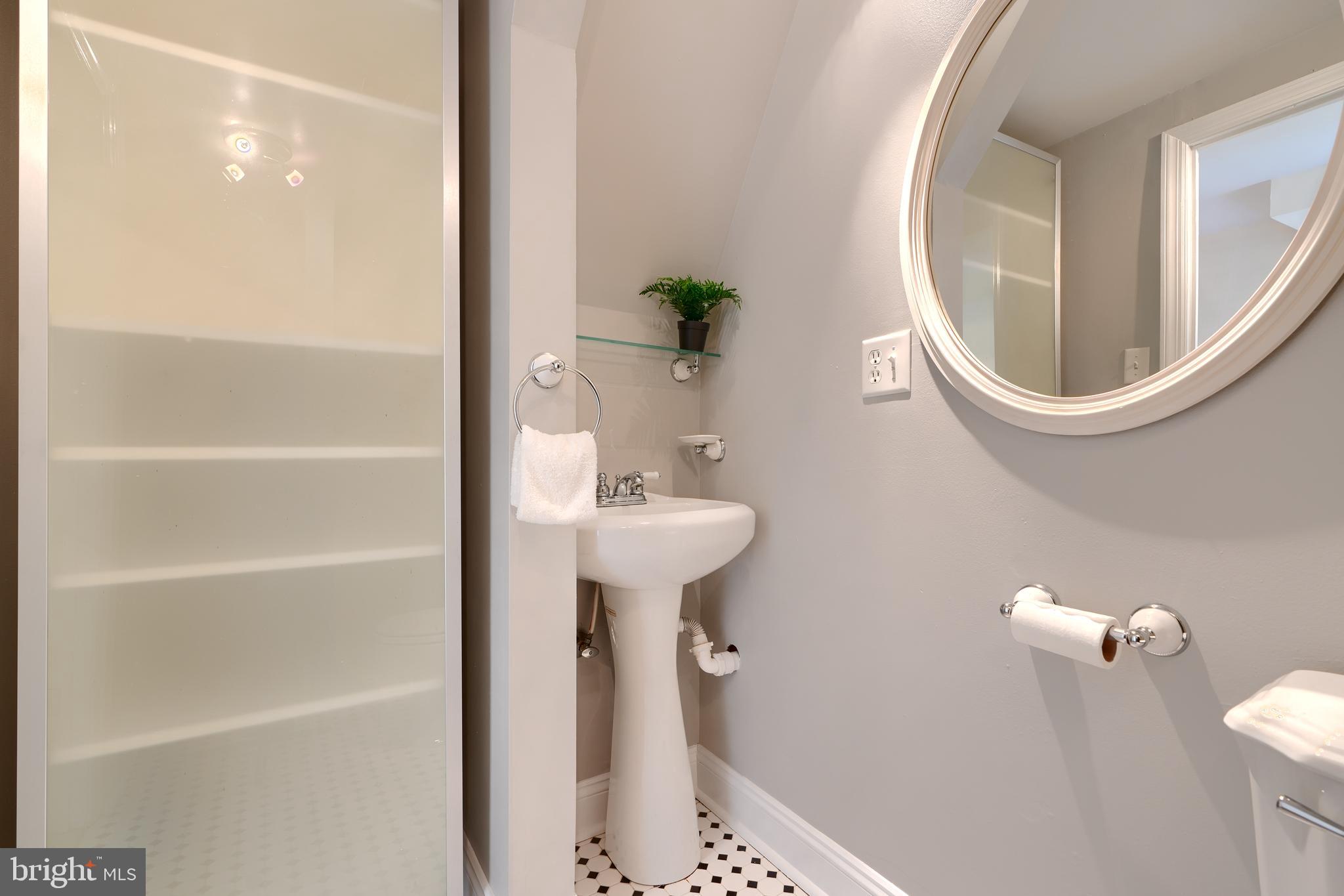 1142 Riverside Avenue Baltimore, MD 21230 - Photo 23 of 41 a bathroom with a sink a mirror a toilet and a mirror