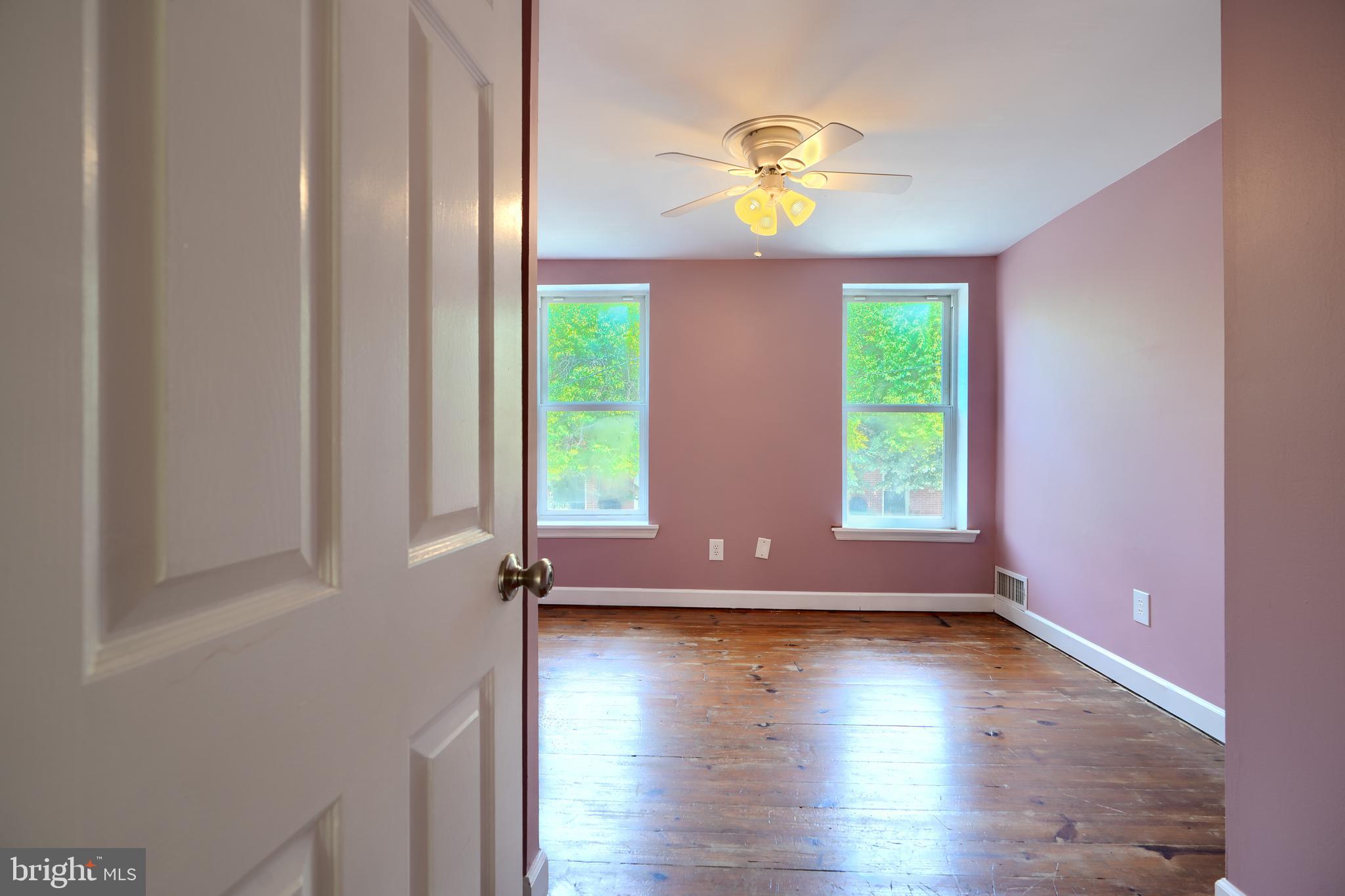 1142 Riverside Avenue Baltimore, MD 21230 - Photo 26 of 41 an empty room with wooden floor and windows