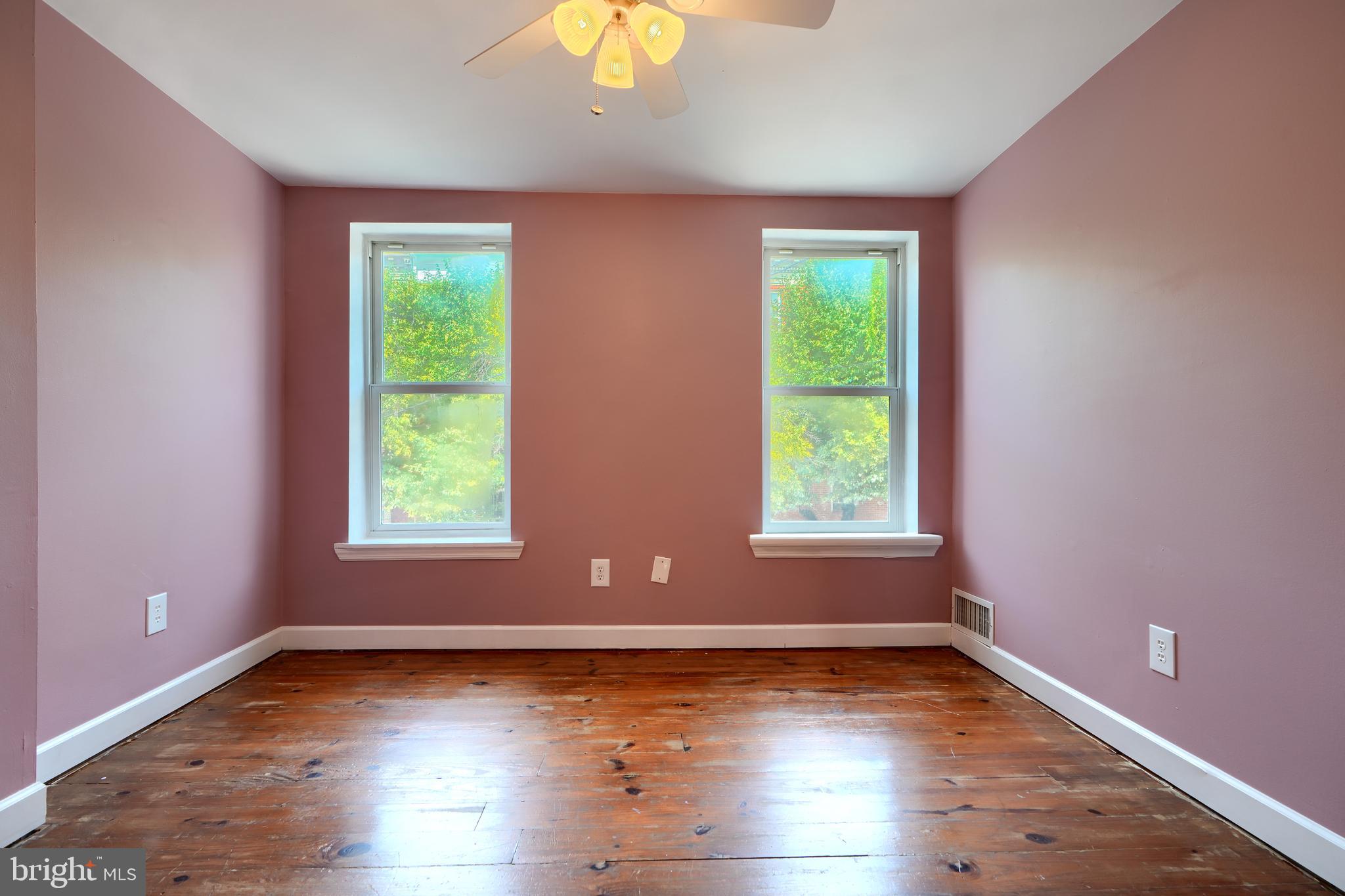 1142 Riverside Avenue Baltimore, MD 21230 - Photo 28 of 41 an empty room with wooden floor and windows