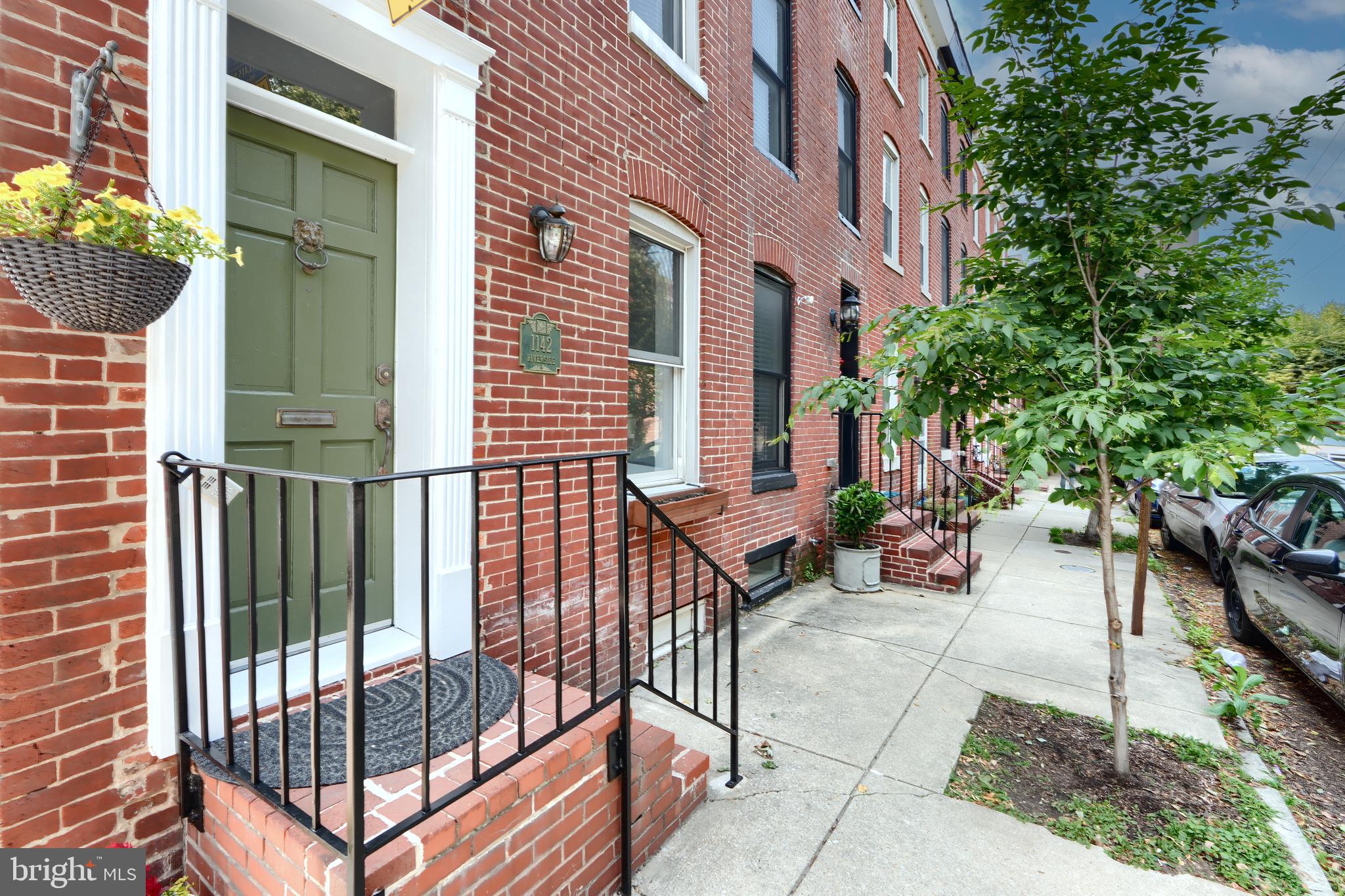 1142 Riverside Avenue Baltimore, MD 21230 - Photo 3 of 41 a view of a brick house with many windows and plants