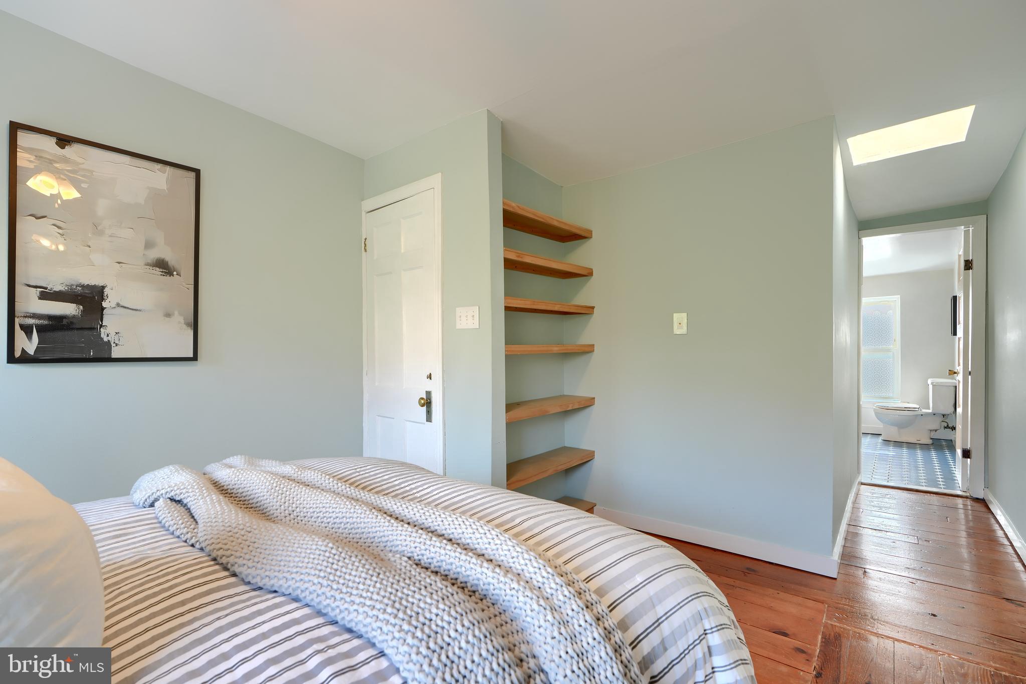 1142 Riverside Avenue Baltimore, MD 21230 - Photo 34 of 41 a bedroom with a bed and a painting on the wall