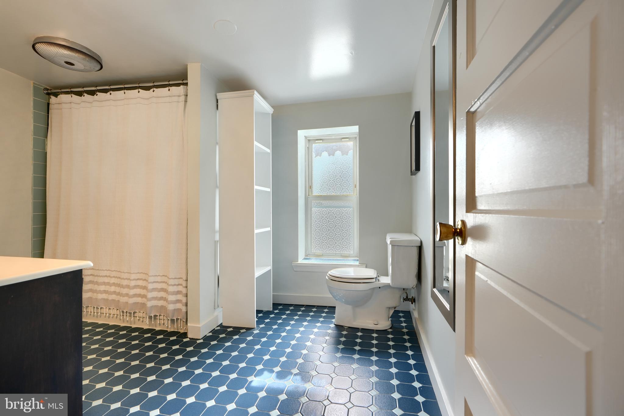 1142 Riverside Avenue Baltimore, MD 21230 - Photo 37 of 41 a bathroom with a toilet and a shower