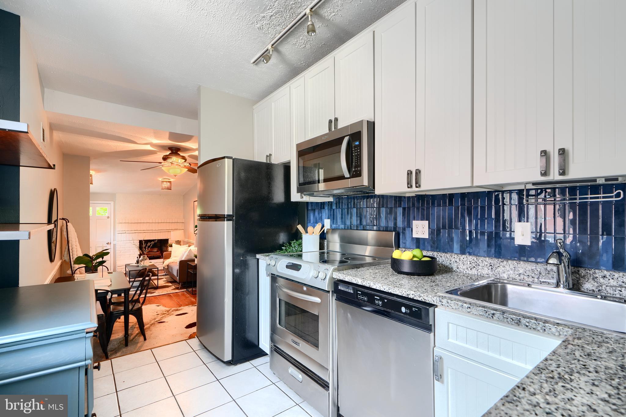 1142 Riverside Avenue Baltimore, MD 21230 - Photo 6 of 41 a kitchen with stainless steel appliances granite countertop a stove refrigerator sink and cabinets