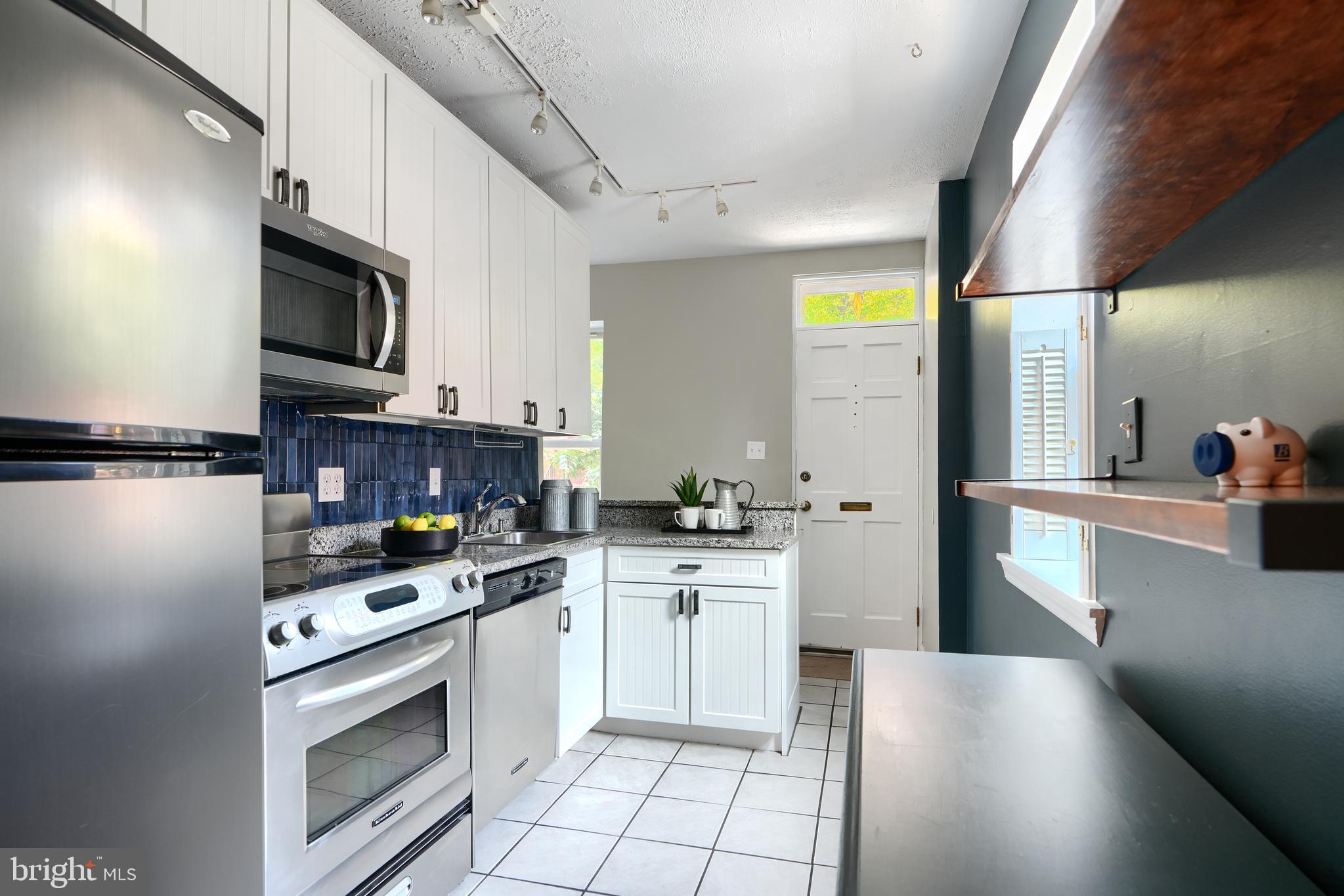 1142 Riverside Avenue Baltimore, MD 21230 - Photo 7 of 41 a kitchen with stainless steel appliances granite countertop a refrigerator a stove top oven a sink and dishwasher