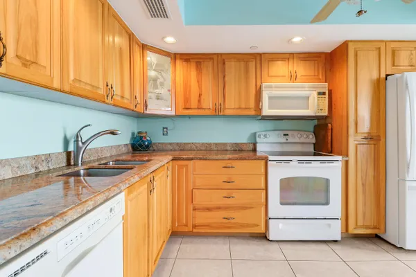 a kitchen with stainless steel appliances granite countertop a sink and cabinets