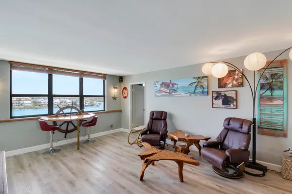 a living room with furniture a rug and a large window