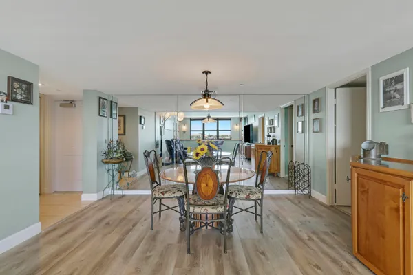 a view of a dining room with furniture window and wooden floor