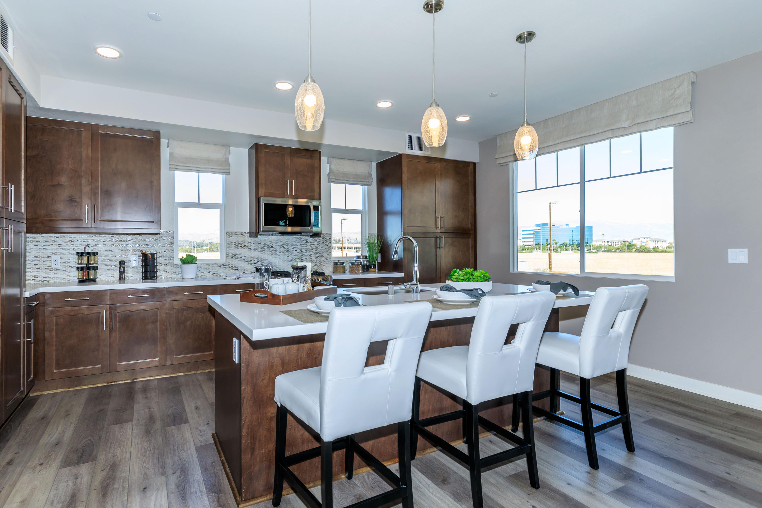 2820 Wagon Wheel Road, Unit 202 Oxnard, CA 93036 - Photo 4 of 28 a kitchen with a dining table chairs and microwave