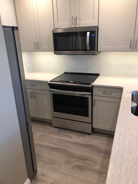 8411 Placida Road, Unit 205 Placida, FL 33946 - Photo 19 of 51 a kitchen with stainless steel appliances a stove a microwave and a sink