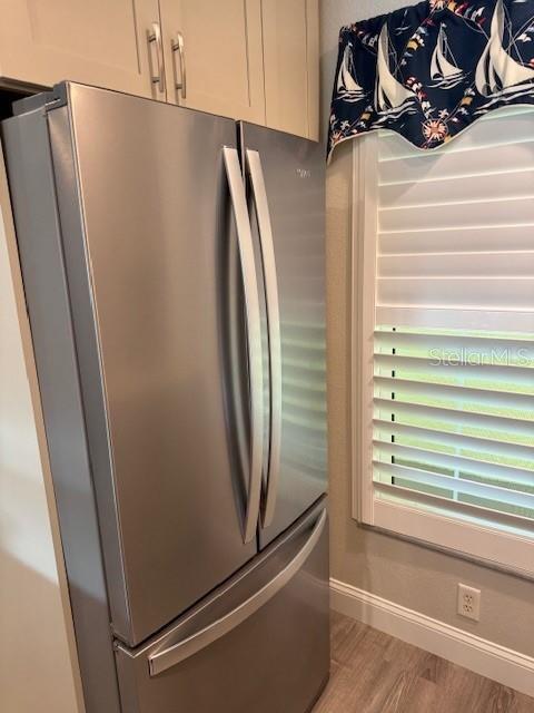 8411 Placida Road, Unit 205 Placida, FL 33946 - Photo 21 of 51 a view of a refrigerator and wooden floor