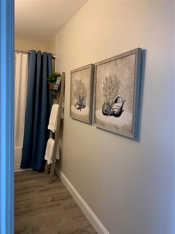 8411 Placida Road, Unit 205 Placida, FL 33946 - Photo 25 of 51 a view of a hallway with wooden door and furniture