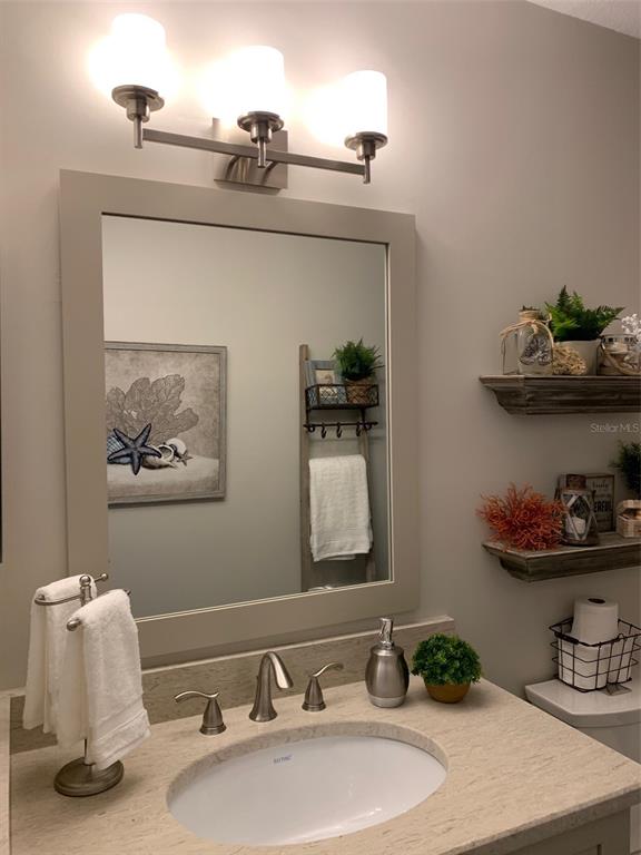 8411 Placida Road, Unit 205 Placida, FL 33946 - Photo 26 of 51 a bathroom with a sink and a mirror
