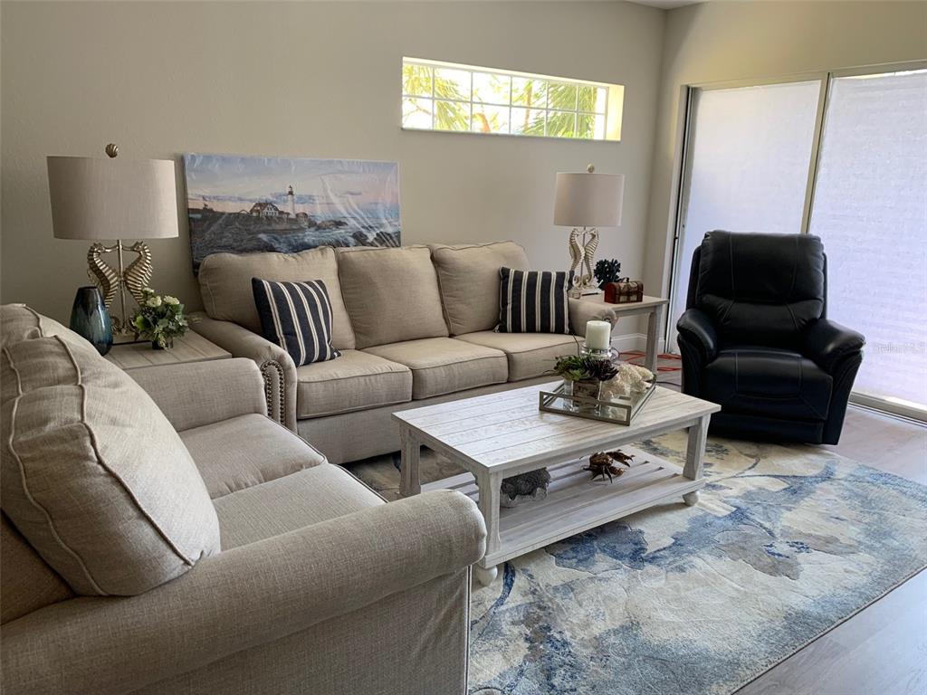8411 Placida Road, Unit 205 Placida, FL 33946 - Photo 31 of 51 a living room with furniture and wooden floor