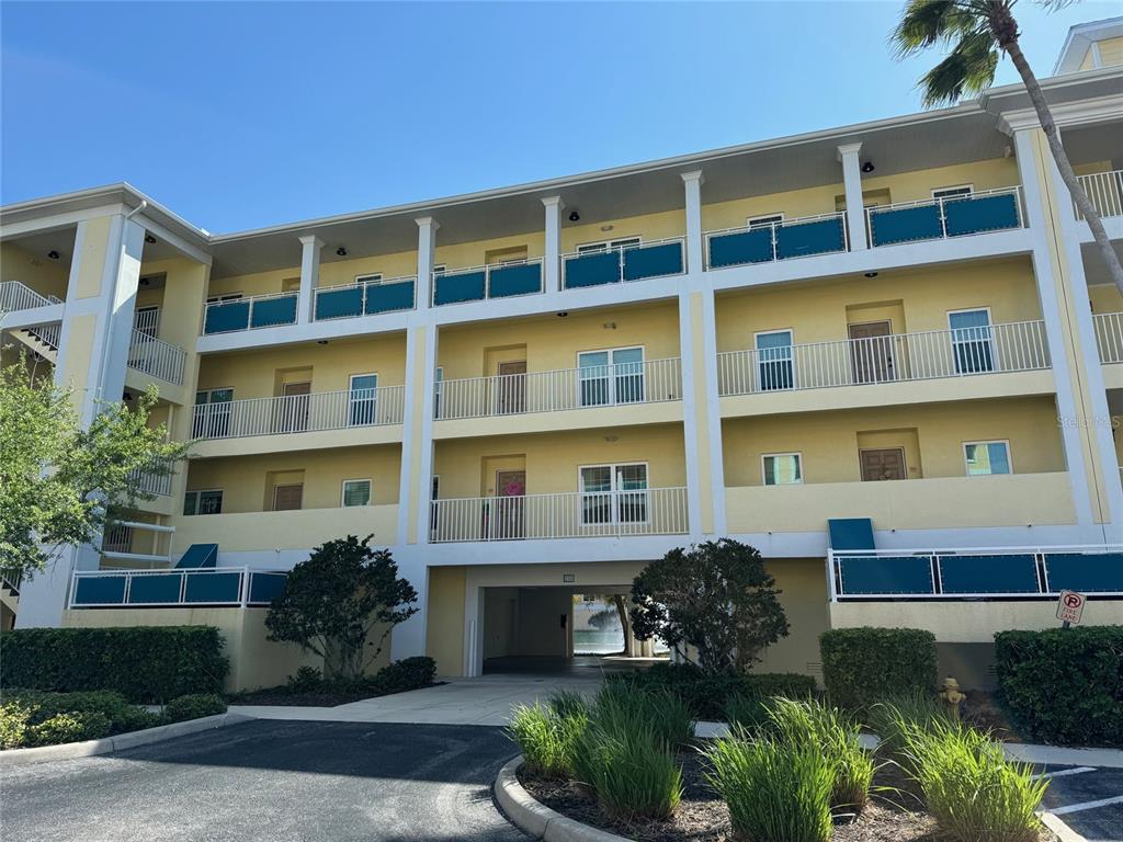 8411 Placida Road, Unit 205 Placida, FL 33946 - Photo 44 of 51 a front view of a residential apartment building with a yard