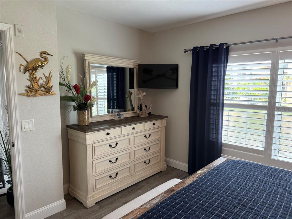 8411 Placida Road, Unit 205 Placida, FL 33946 - Photo 5 of 51 a room with furniture a flat screen tv and a window