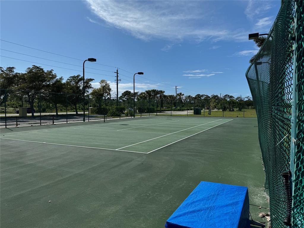 8411 Placida Road, Unit 205 Placida, FL 33946 - Photo 51 of 51 a view of a tennis ground with large trees