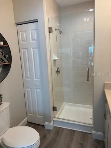 a bathroom with a toilet and a shower