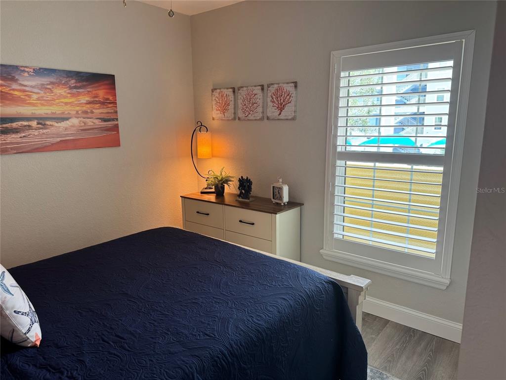 8411 Placida Road, Unit 205 Placida, FL 33946 - Photo 10 of 51 a bedroom with a bed and a window