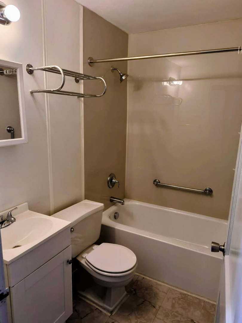 1003 41st Street Moline, IL 61265 - Photo 11 of 17 a bathroom with a sink toilet and shower