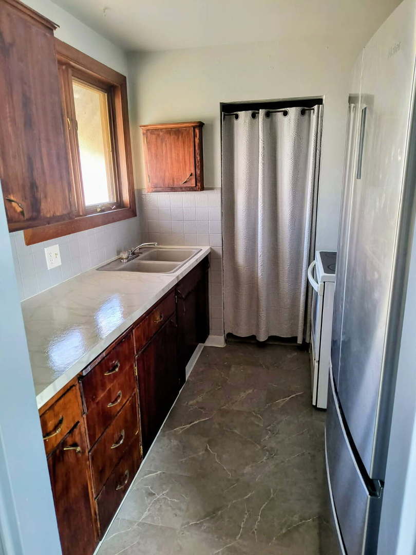 1003 41st Street Moline, IL 61265 - Photo 7 of 17 a kitchen with a refrigerator and a sink