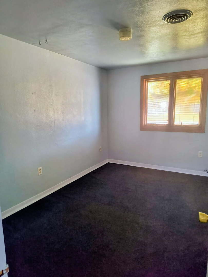 1003 41st Street Moline, IL 61265 - Photo 8 of 17 an empty room with a window