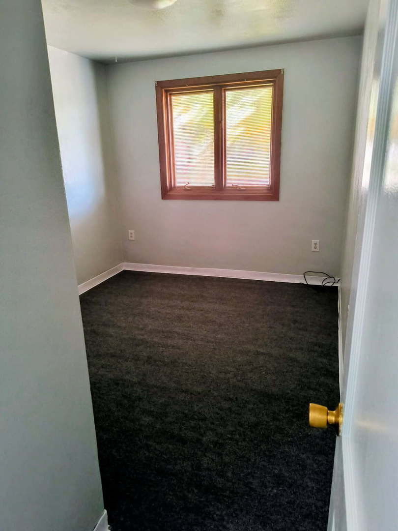 1003 41st Street Moline, IL 61265 - Photo 9 of 17 an empty room with wooden floor and a window