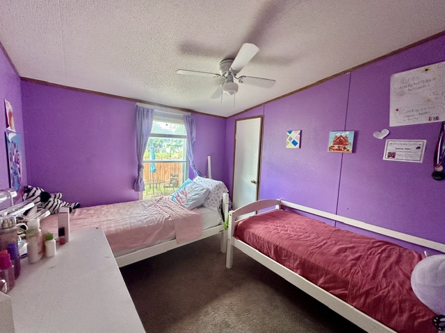 106 Ramirez Street Kyle, TX 78640 - Photo 13 of 19 Well-lit and functional, this bedroom offers ample space and individual comfort.
