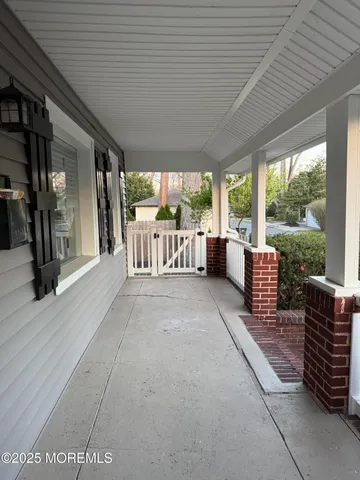 a living room with furniture tv and large windows