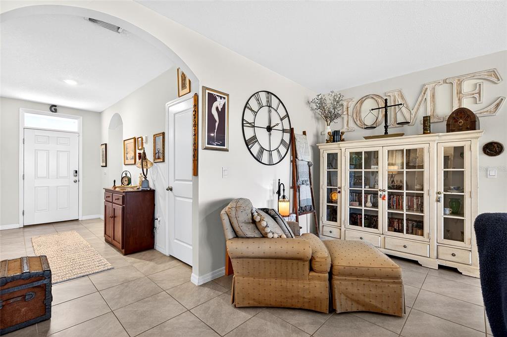 508 Hickory Course Loop Ocala, FL 34472 - Photo 12 of 40 a living room with furniture a window and a clock