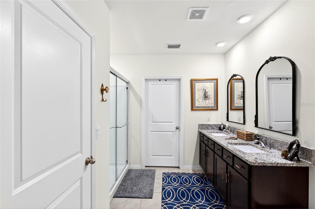508 Hickory Course Loop Ocala, FL 34472 - Photo 19 of 40 a bathroom with a double vanity sink and a mirror