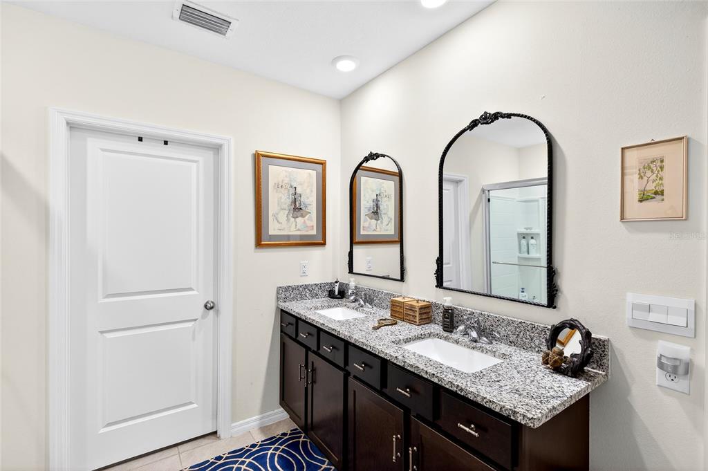 508 Hickory Course Loop Ocala, FL 34472 - Photo 20 of 40 a bathroom with a granite countertop sink and a mirror