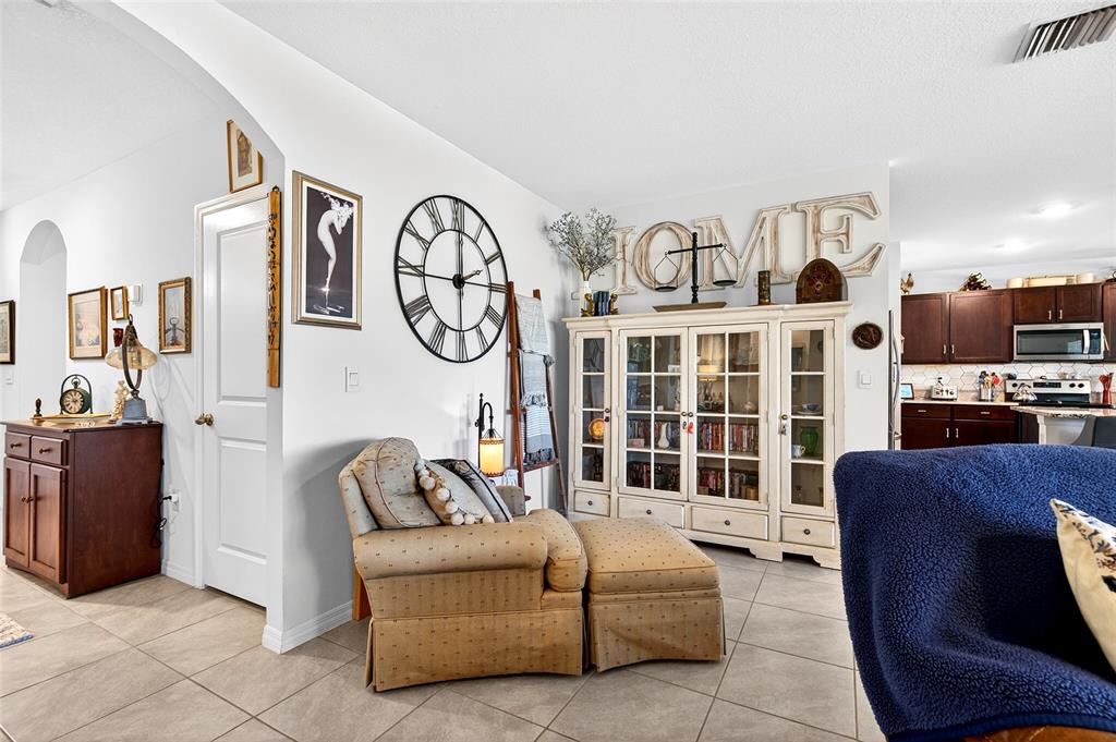 508 Hickory Course Loop Ocala, FL 34472 - Photo 24 of 40 a living room with furniture a flat screen tv and kitchen view