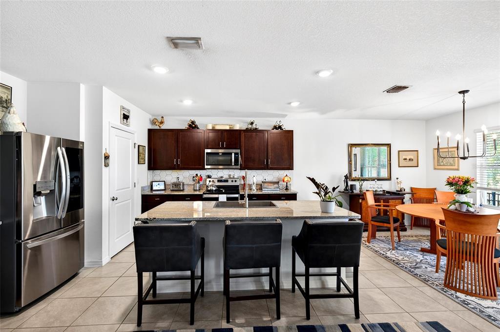 508 Hickory Course Loop Ocala, FL 34472 - Photo 28 of 40 a large kitchen with a table and chairs