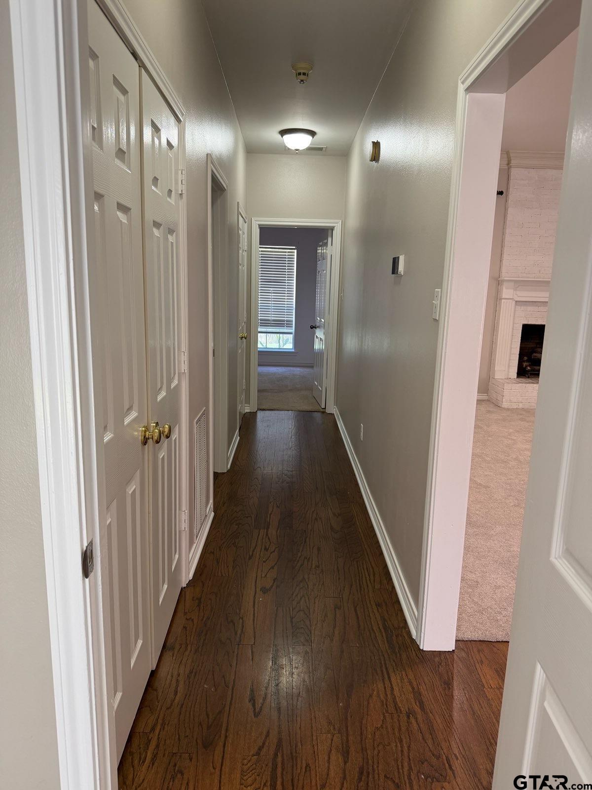 3204 Pebblebrook Circle Tyler, TX 75707 - Photo 7 of 18 a view of a hallway with wooden floor