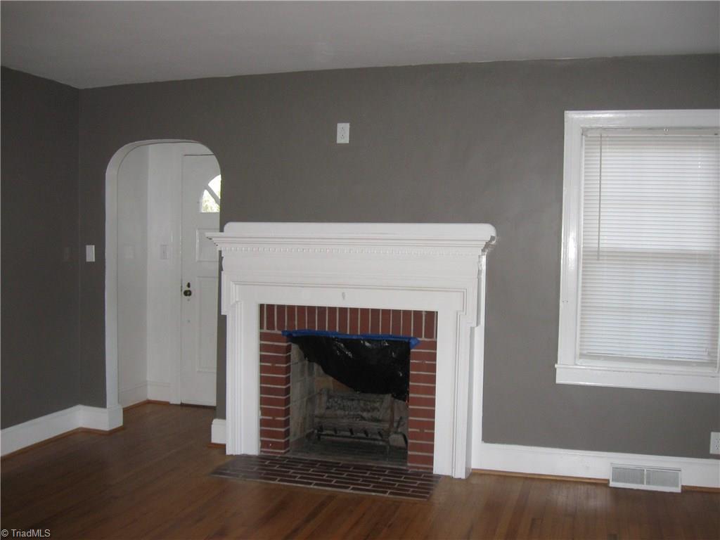 9180 Highway 700 Ruffin, NC 27326 - Photo 3 of 16 Living Room: Beautiful fire place; notice the archway to foyer; hardwood flooring.