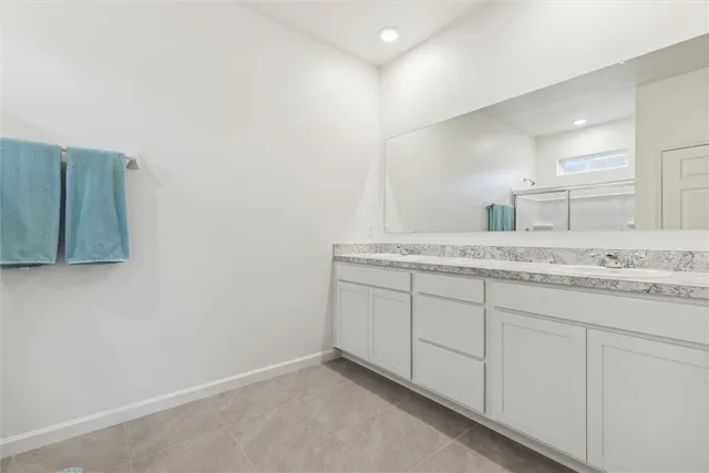 a bathroom with a granite countertop sink and vanity