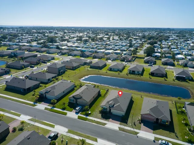 an aerial view of multiple houses with a city