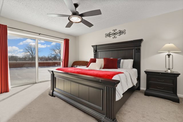 225 Main Street, Unit 214 Roselle, IL 60172 - Photo 12 of 27 a bedroom with a bed and a window