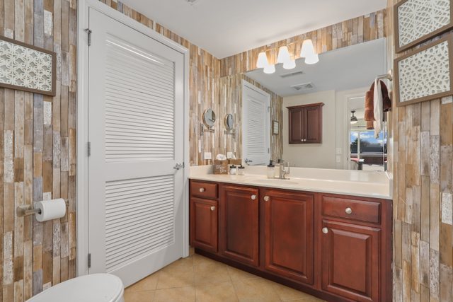 225 Main Street, Unit 214 Roselle, IL 60172 - Photo 14 of 27 a spacious bathroom with a double vanity sink and a mirror