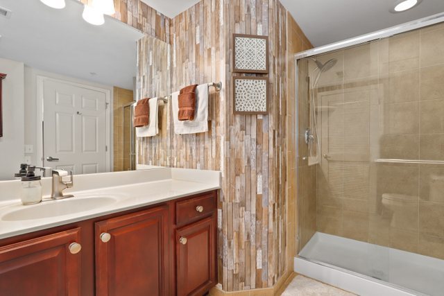 225 Main Street, Unit 214 Roselle, IL 60172 - Photo 15 of 27 a bathroom with a sink and a mirror