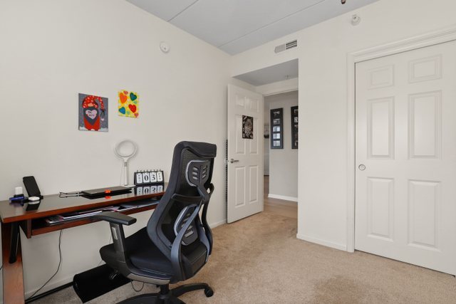 225 Main Street, Unit 214 Roselle, IL 60172 - Photo 20 of 27 a view of a workspace with furniture and wooden floor