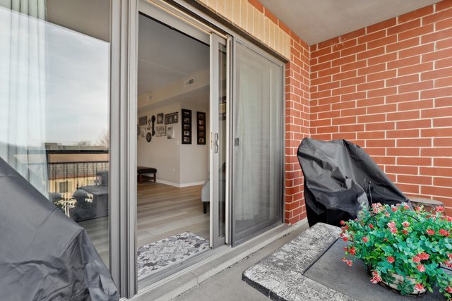 225 Main Street, Unit 214 Roselle, IL 60172 - Photo 23 of 27 a view of a balcony with chair and next to a yard