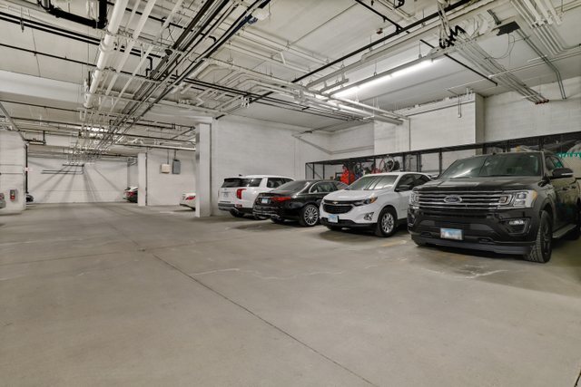 225 Main Street, Unit 214 Roselle, IL 60172 - Photo 26 of 27 a view of cars parked in a parking