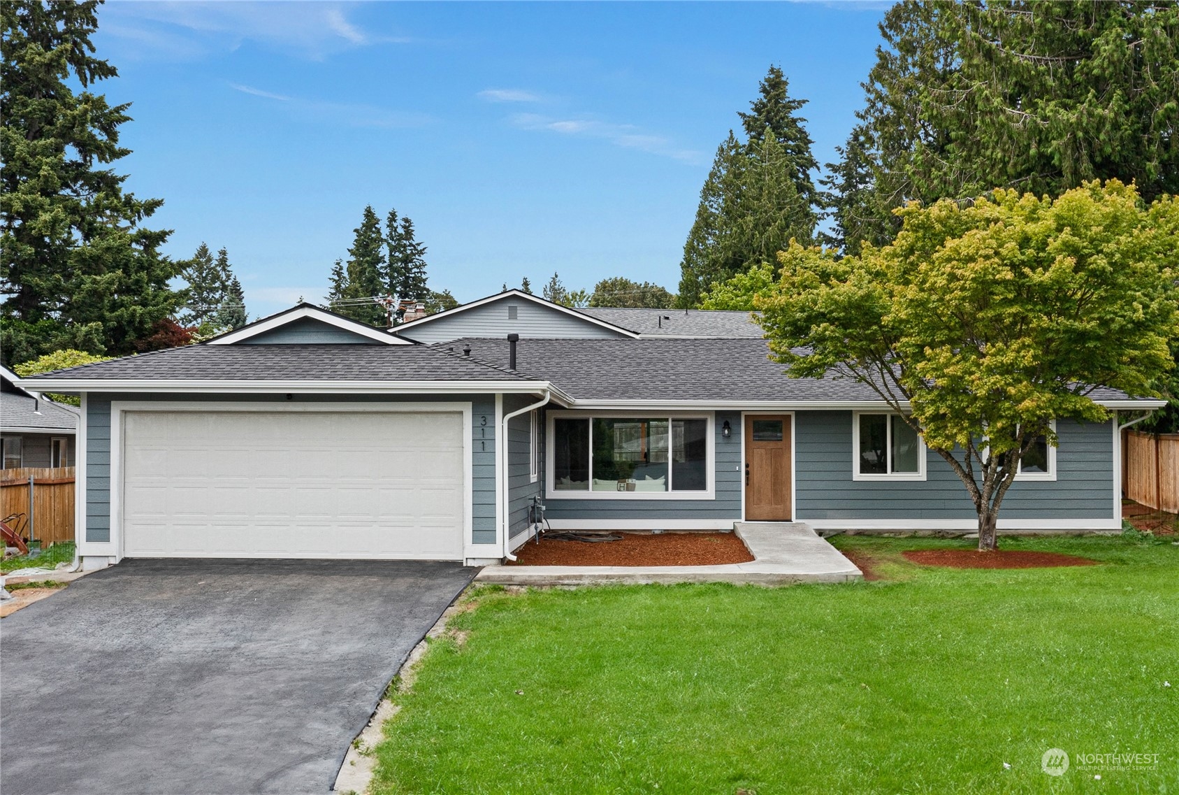 a front view of house with yard and green space