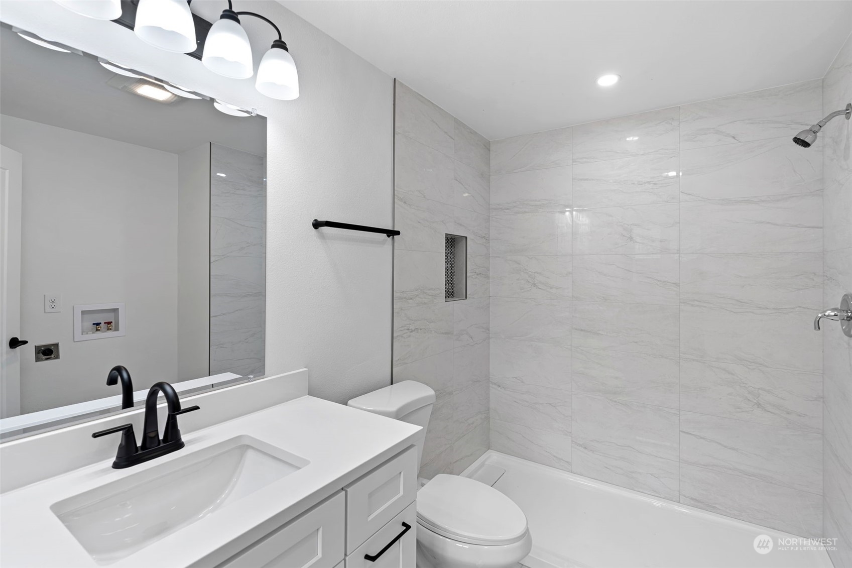 311 217th Place Southwest Bothell, WA 98021 - Photo 13 of 28 a bathroom with a sink a toilet a mirror and shower