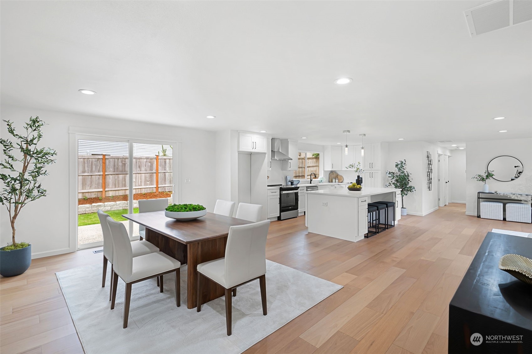 311 217th Place Southwest Bothell, WA 98021 - Photo 14 of 28 a dining hall with stainless steel appliances a dining table and chairs with kitchen view
