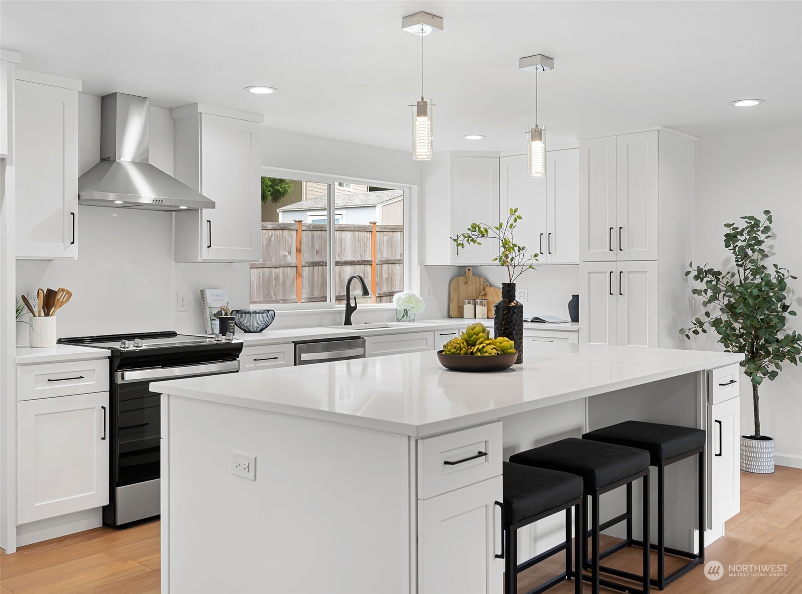 311 217th Place Southwest Bothell, WA 98021 - Photo 6 of 28 a kitchen with kitchen island a stove a table and chairs in it