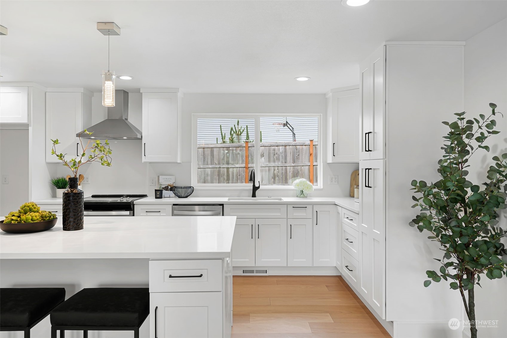 311 217th Place Southwest Bothell, WA 98021 - Photo 7 of 28 a kitchen with a white center island and cabinets
