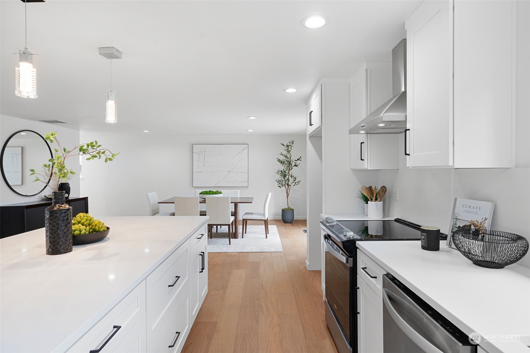 311 217th Place Southwest Bothell, WA 98021 - Photo 8 of 28 a kitchen with a sink dishwasher stove and white cabinets with wooden floor