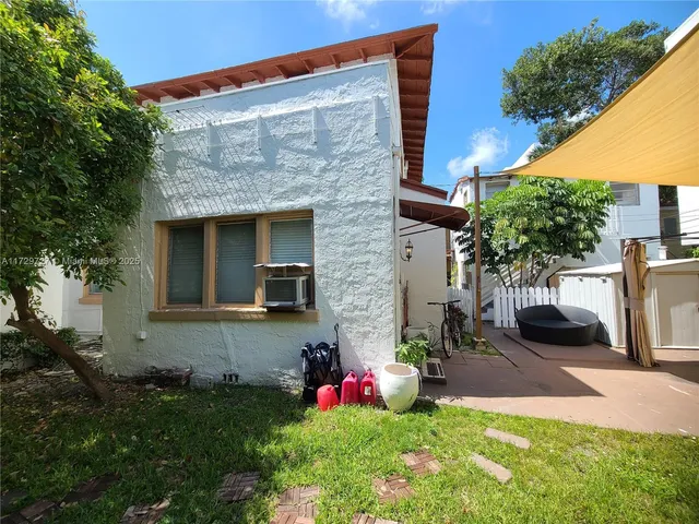a view of a house with a sink and potted plants